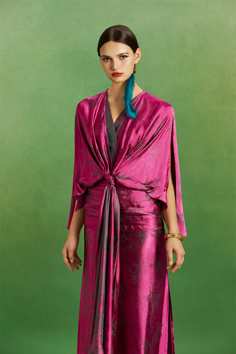 Le Thanh Hoa Ma Chau heritage maxi dress featuring traditional embroidery and vibrant fabric in a full-length design.