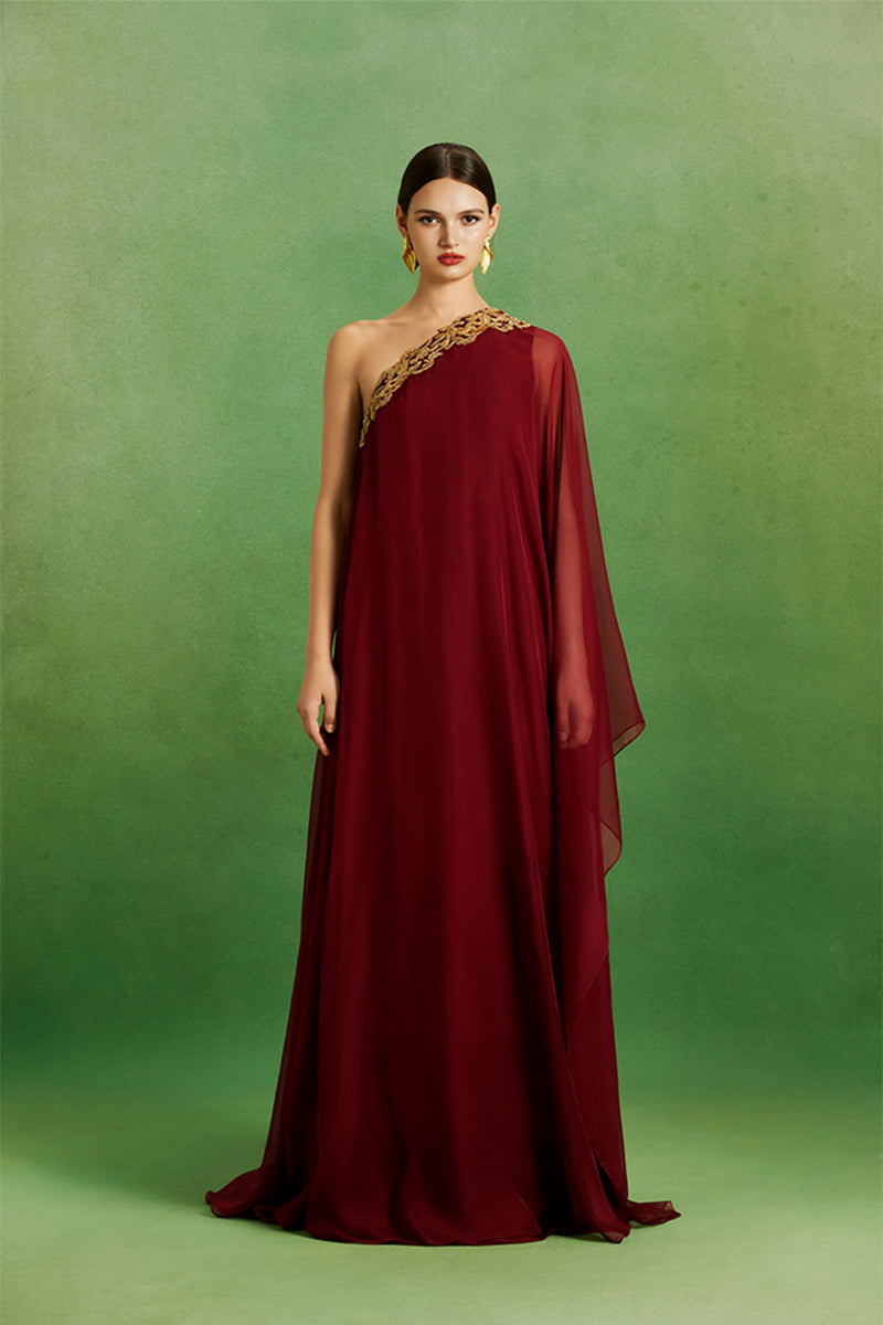 Elegant burgundy flow gown by Le Thanh Hoa featuring soft fabric and intricate draping, perfect for formal occasions.