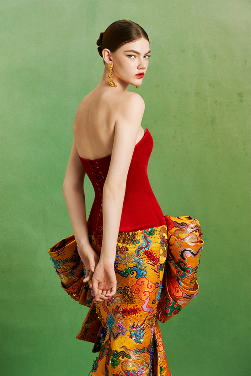 Elegant imperial bow gown by Le Thanh Hoa featuring intricate design and flowing fabric, perfect for formal occasions.
