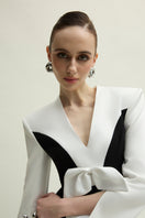 Elegant white and black Shalom gown by Jenny K Tran, featuring a flowing design and intricate details.