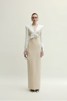 Elegant white and beige Shalom gown by Jenny K Tran, showcasing flowing fabric and intricate design details.