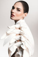 White Liya bow-sleeve shirt with long sleeves and a classic collar, displayed on a hanger.
