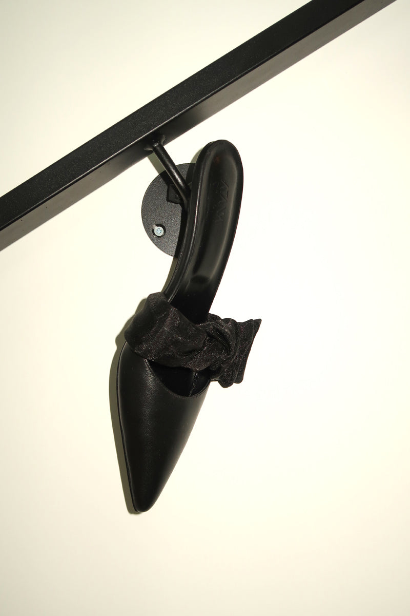 Black side tie mule heels by House of Atana featuring nappa leather and mesh, with a stylish slip-on design.