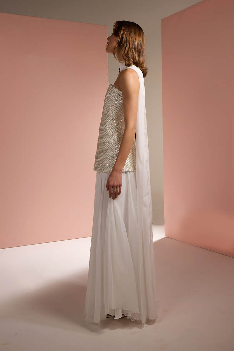 Joanna Andraos white strapless top and skirt co-ord set with matching scarf, shown from side view.