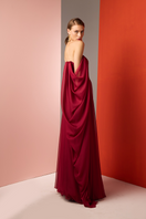 Red strapless gown by Joanna Andraos, featuring elegant design and flowing fabric, shown from a side view.