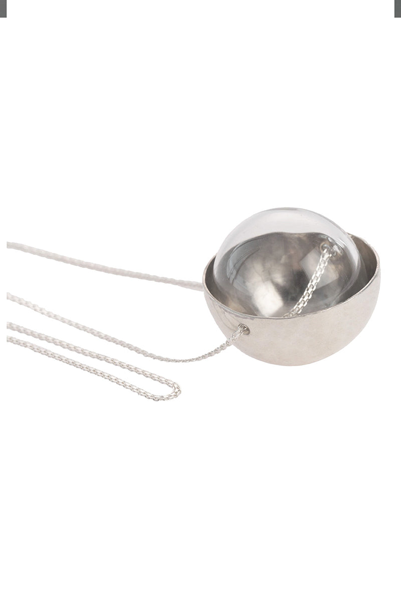 Silver and glass half-sphere necklace by MAZ Manuela Ávarez featuring a sleek silver chain and a translucent glass pendant.