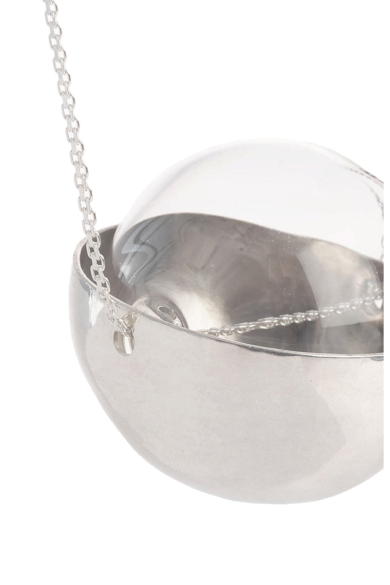 Silver and glass half-sphere necklace by MAZ Manuela Álvarez featuring a sleek, modern design with a silver chain and glass pendant.