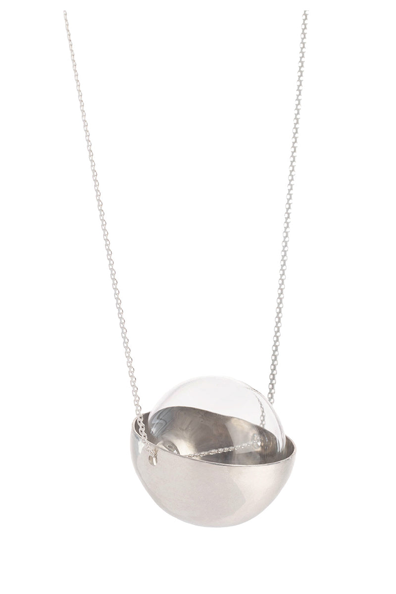 Silver and glass half-sphere necklace by MAZ Manuela Álvarez featuring a sleek silver chain and a translucent glass pendant.