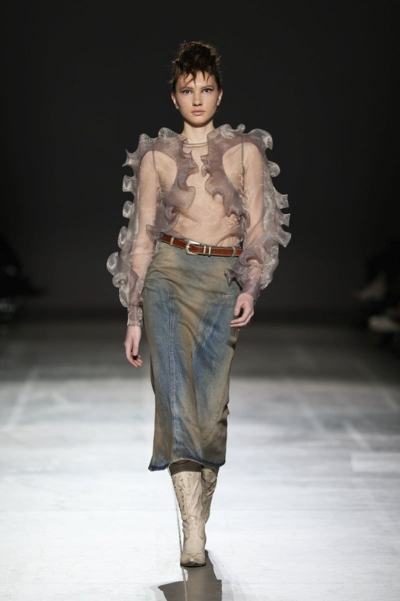 NADYA DZYAK rust-colored denim midi skirt displayed on a model, showcasing its length and classic denim texture.