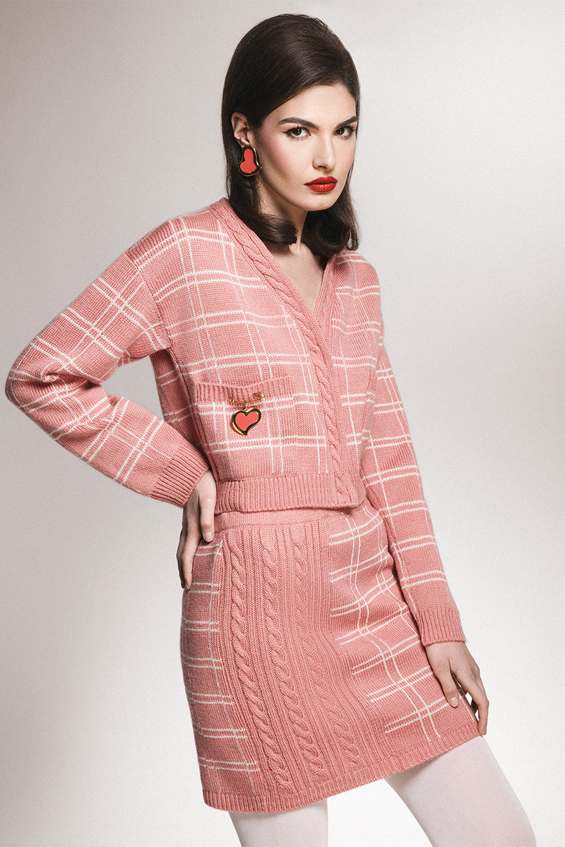Soft pink checked knit mini skirt by Liya, featuring a cozy knitted fabric and classic plaid pattern.
