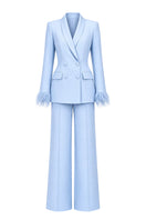 Baby blue hourglass suit set with feather details by Joanna Andraos, featuring a stylish and elegant design.