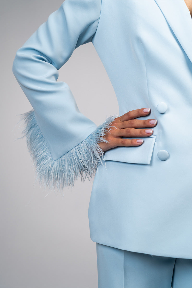 Baby blue hourglass suit set with feather details by Joanna Andraos, featuring a stylish and elegant design.