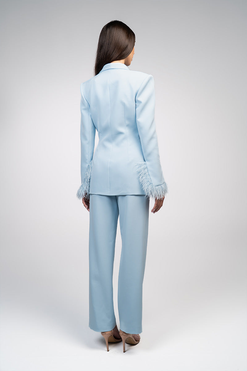 Baby blue hourglass suit set with feather details from Joanna Andraos, featuring a stylish, elegant design for special occasions.