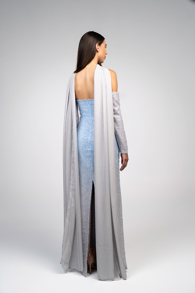 Baby blue to silver ombré embroidered gown by Joanna Andraos, featuring delicate embroidery and flowing fabric.