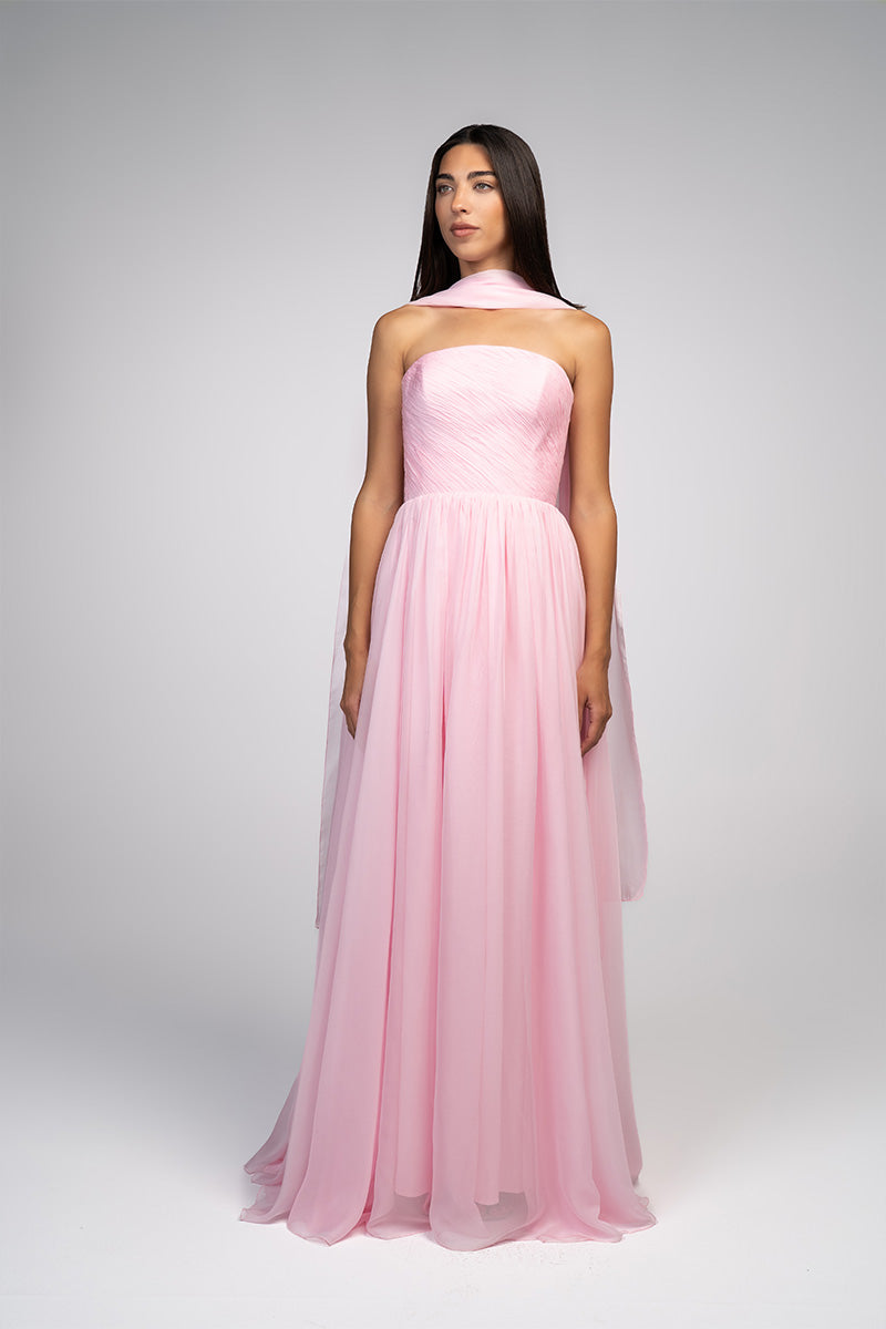 Elegant blush evening gown by Joanna Andraos featuring flowing fabric and intricate detailing, perfect for formal occasions.