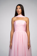 Elegant blush evening gown by Joanna Andraos, featuring flowing fabric and intricate detailing, perfect for formal occasions.