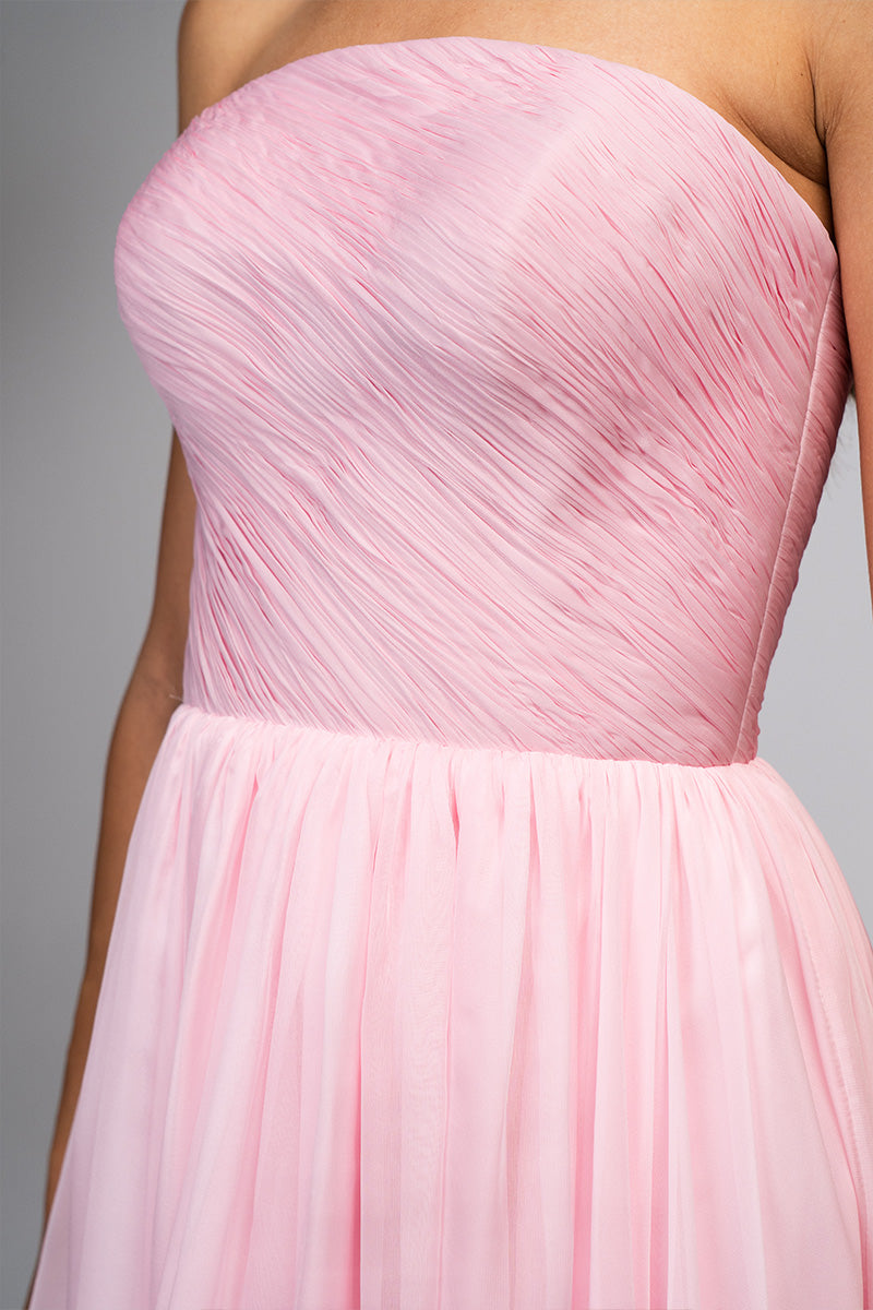 Elegant blush evening gown by Joanna Andraos featuring flowing fabric and intricate detailing, perfect for formal occasions.