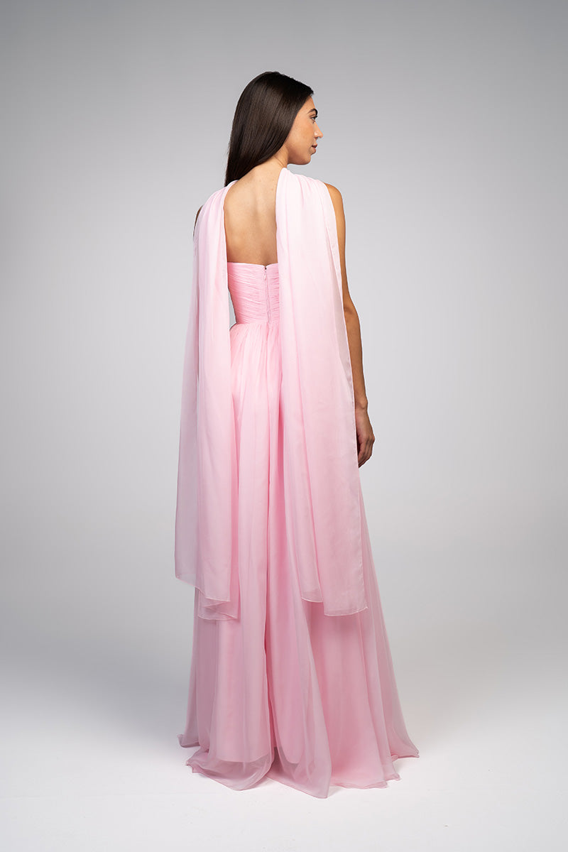 Elegant blush evening gown by Joanna Andraos, featuring flowing fabric and intricate details, perfect for formal occasions.