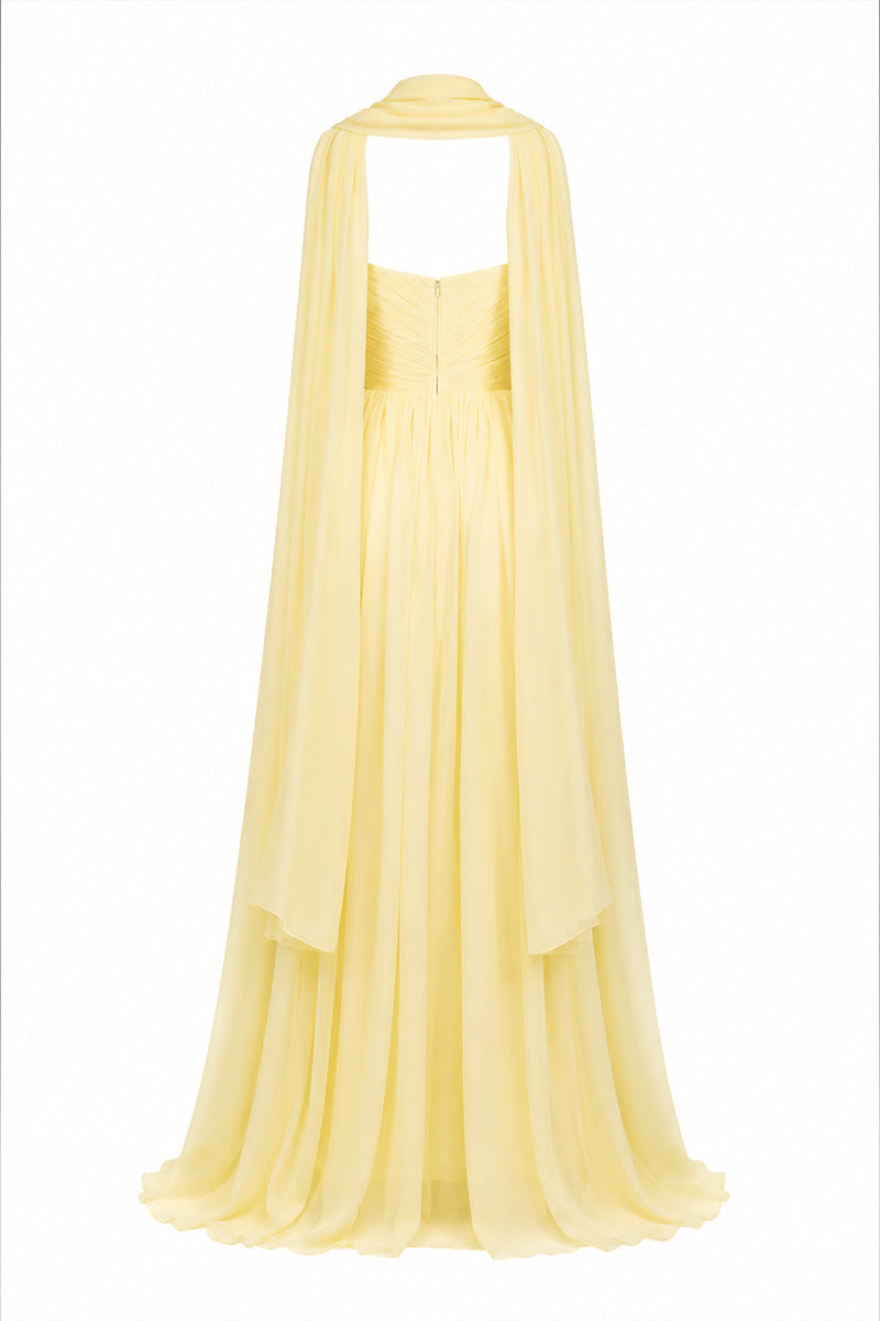 Yellow strapless gown by Joanna Andraos, featuring elegant design and flowing fabric, perfect for formal occasions.