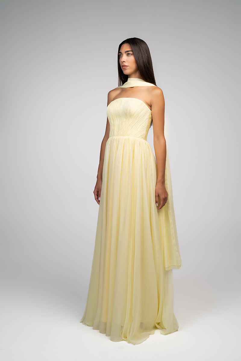 Yellow strapless gown by Joanna Andraos featuring a flowing design and elegant silhouette, perfect for formal occasions.