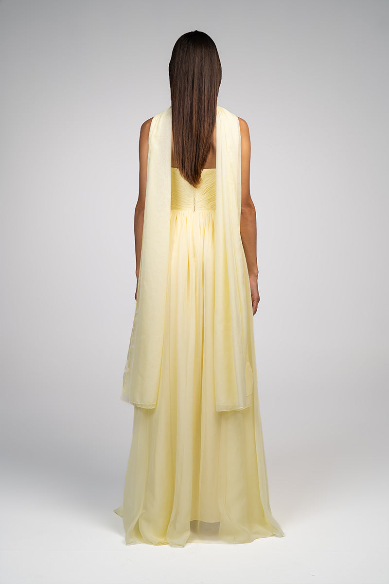Yellow strapless gown by Joanna Andraos featuring a flowing design and elegant silhouette, perfect for formal occasions.
