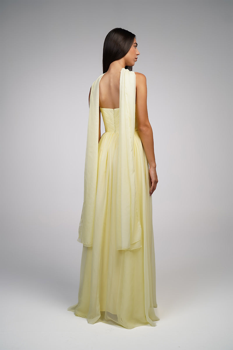 Yellow strapless gown by Joanna Andraos featuring a flowing silhouette and elegant design, perfect for formal occasions.