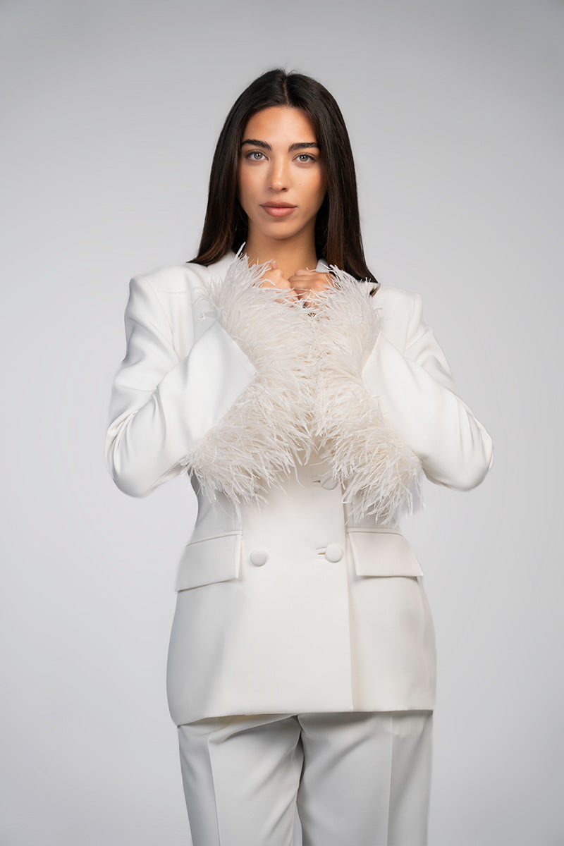 Ivory white hourglass suit with feather details by Joanna Andraos, featuring a fitted blazer and matching trousers.