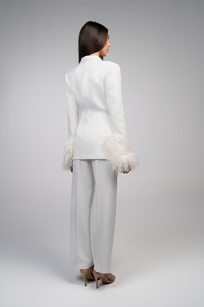 Ivory white hourglass suit set with feather details by Joanna Andraos, featuring tailored fit and elegant design.