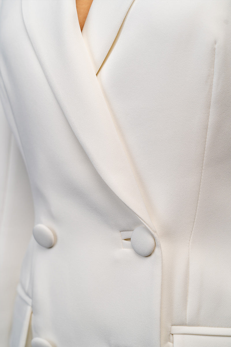 Ivory white hourglass suit with feather details, stylish Joanna Andraos suit set, featuring a fitted silhouette and elegant design.