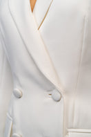 Ivory white hourglass suit set with feather details by Joanna Andraos, featuring fitted design and elegant feather accents.