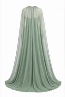 Elegant strapless Joanna Andraos gown with a detachable cape, shown on a model in a formal setting.
