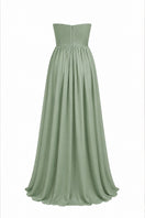 Elegant strapless gown with a detachable cape by Joanna Andraos, featuring flowing fabric and sophisticated design.