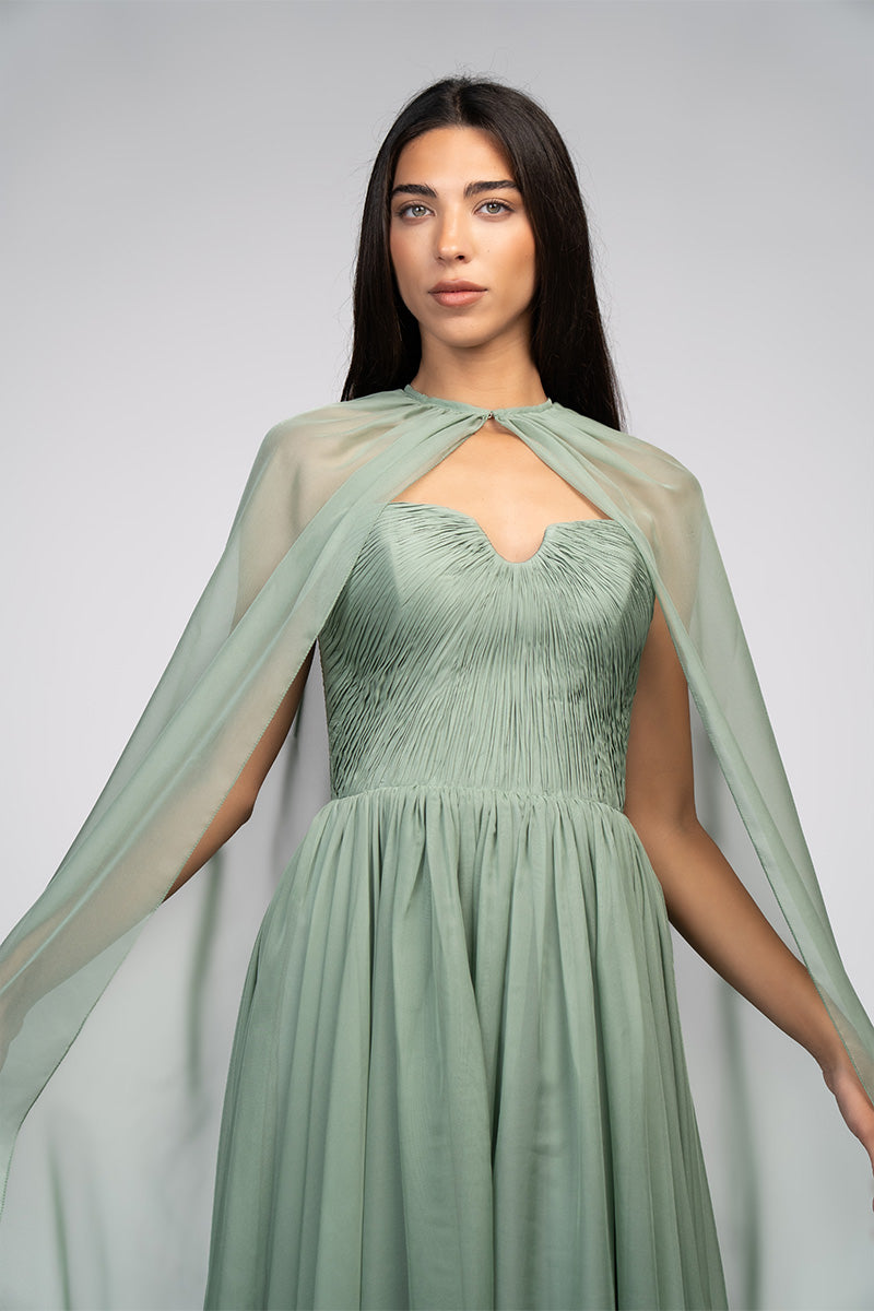 Joanna Andraos strapless gown with a flowing design and detachable cape, elegant evening wear for formal occasions.