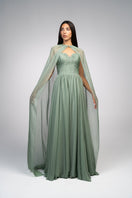 Elegant strapless gown by Joanna Andraos featuring a detachable cape, showcased in a formal evening wear setting.