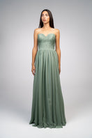 Elegant strapless Joanna Andraos gown with a flowing design and a detachable cape, showcased on a model.