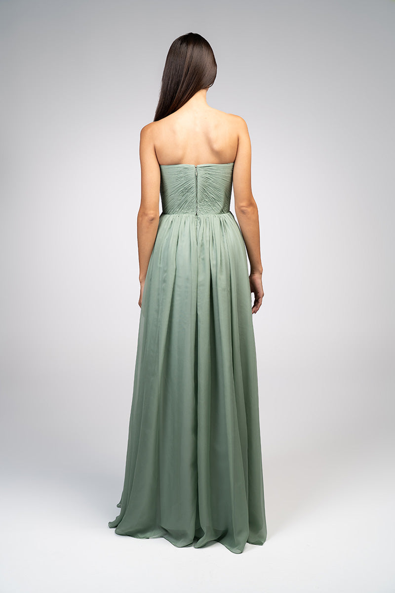 Elegant strapless gown with a detachable cape by Joanna Andraos, featuring flowing fabric and sophisticated design.