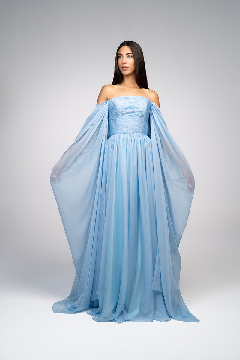 Baby blue strapless gown by Joanna Andraos, elegant formal dress with flowing fabric and a fitted bodice, suitable for special occasions.