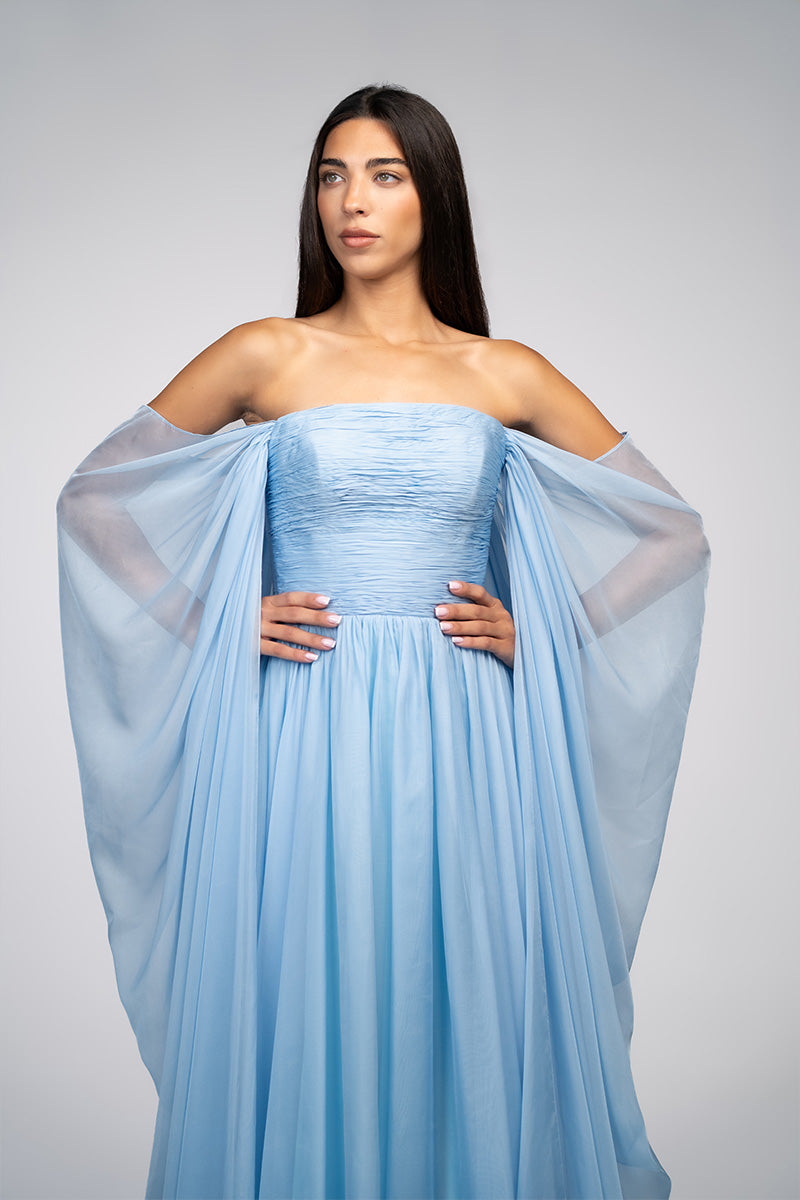 Baby blue strapless gown by Joanna Andraos, elegant formal dress with flowing fabric and intricate detailing.