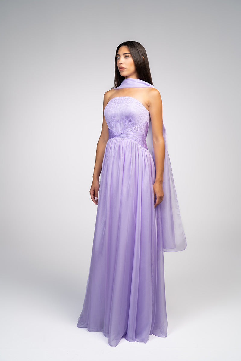 Elegant lavender gown from Joanna Andraos with flowing fabric and delicate details, showcased on a model.