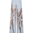 Tinta Latina Solei pants in soft blue print, stylish and comfortable women's pants with vibrant pattern, shown on a model.