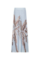 Tinta Latina Solei pants in soft blue print, stylish and comfortable women's pants with vibrant pattern, shown on a model.