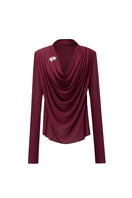 Jenny K Tran Soniq Top in burgundy, stylish women’s blouse with long sleeves and a relaxed fit, displayed on a hanger.