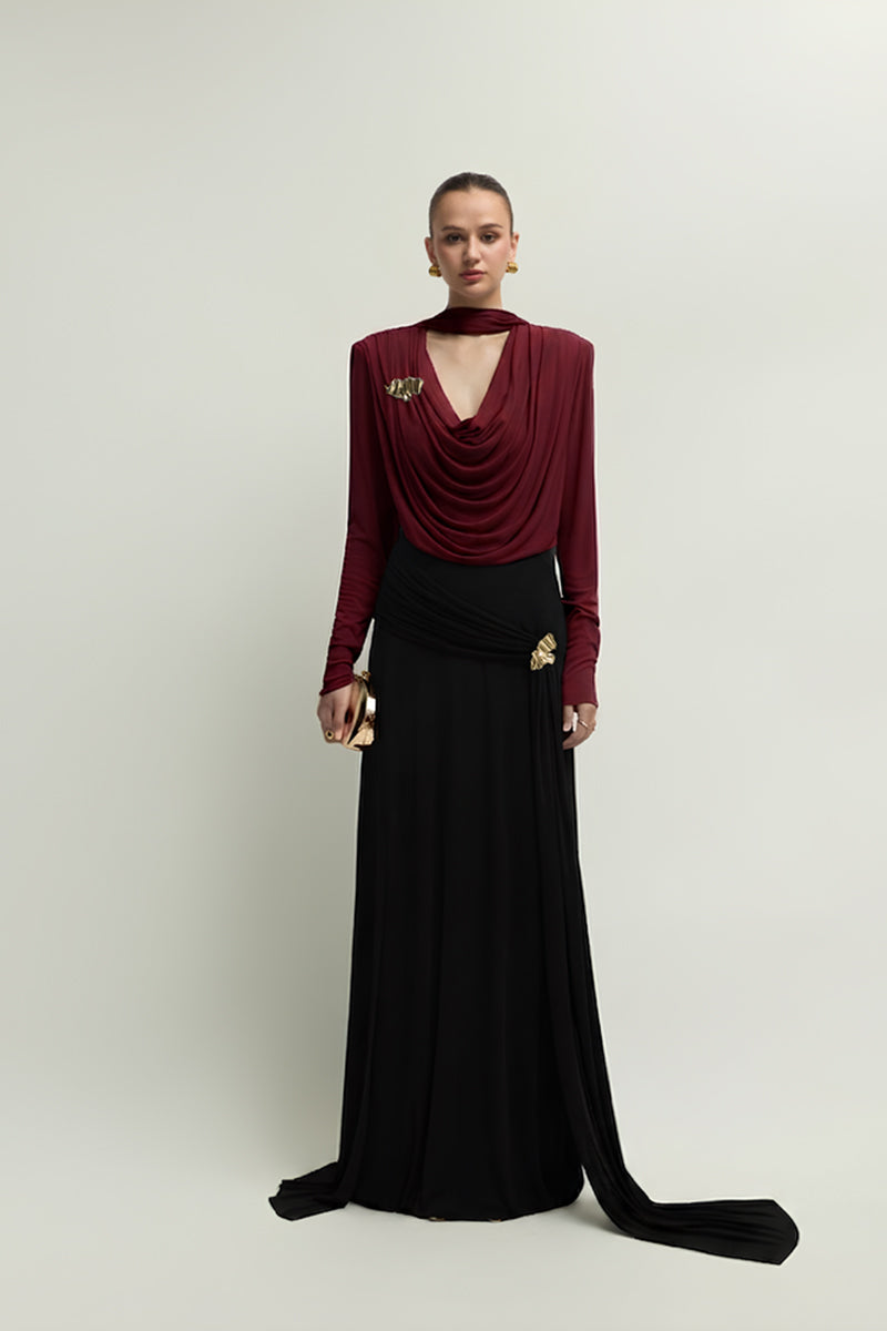 Jenny K Tran Soniq Top in burgundy, stylish women's blouse with long sleeves and a fitted design, displayed on a hanger.