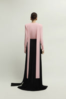 Jenny K Tran Soniq top in baby pink, stylish women's sleeveless blouse with a flowy design, shown on a model.