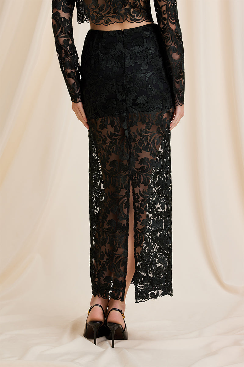Black Scarlett Gasque Sovereign Maxi Skirt shown from the back, flowing fabric and high waist design.