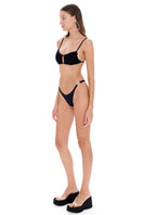Black bikini from Selia Richwood featuring a sleek design, with adjustable straps and a modern fit.