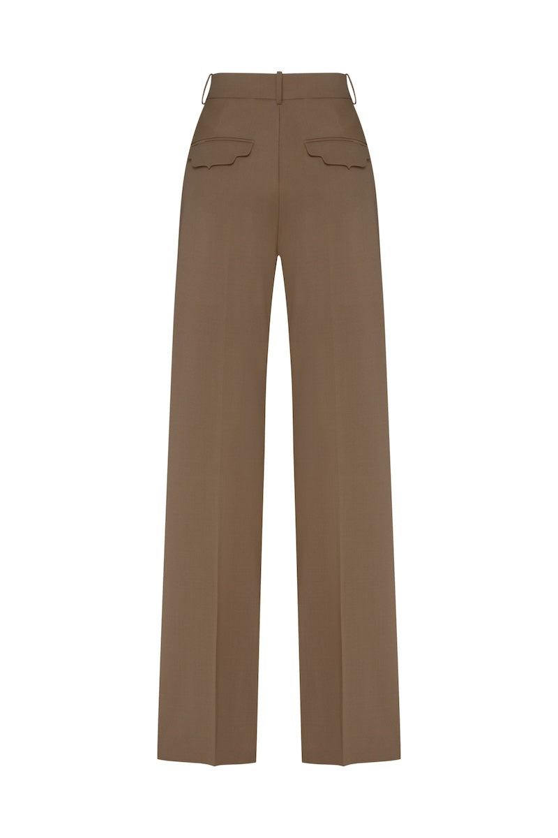 Beige Kemer pants by Podyh, showing a close-up of the tailored waistband and fabric texture.