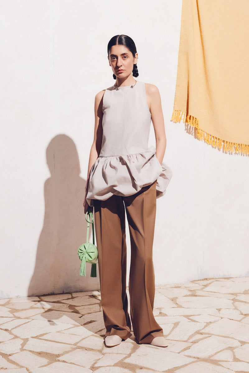 Beige Podyh Kemer pants with tailored fit, featuring front pockets and belt loops, displayed on a plain background.