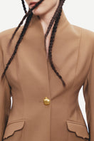 Beige PODYH Kemer Jacket displayed on a hanger, showing its stylish design and fabric texture.
