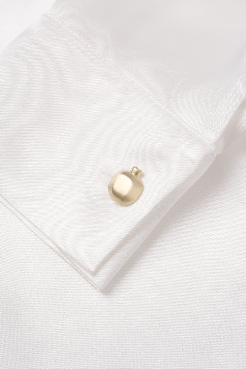 White YAPRAQ blouse from PODYH, a stylish shirt with a clean, elegant design, shown on a hanger with fabric details visible.